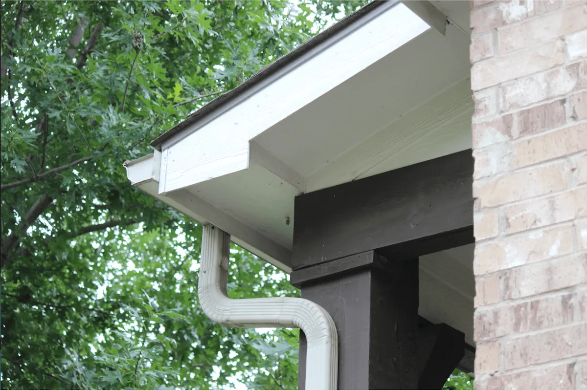 Well-kept aluminum gutters on an established single-family home