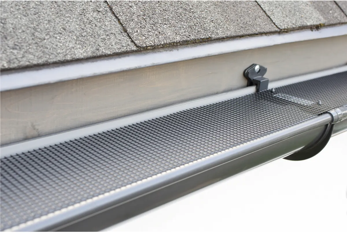 Micro-mesh gutter guard installed on a shingle roof gutter
